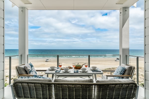 Airbnb living room with ocean view, styled for families and business travellers