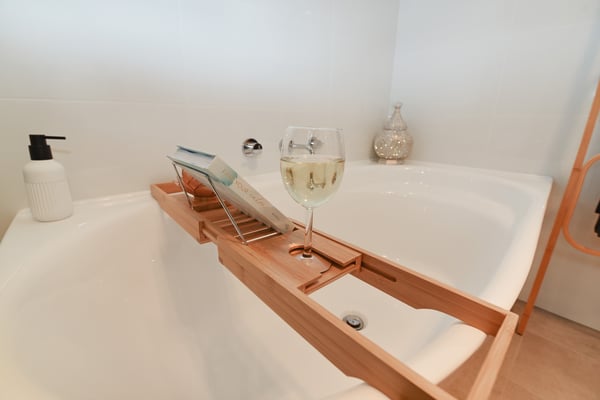Relaxing in a bath with wine and bath salts AirBnB Experience
